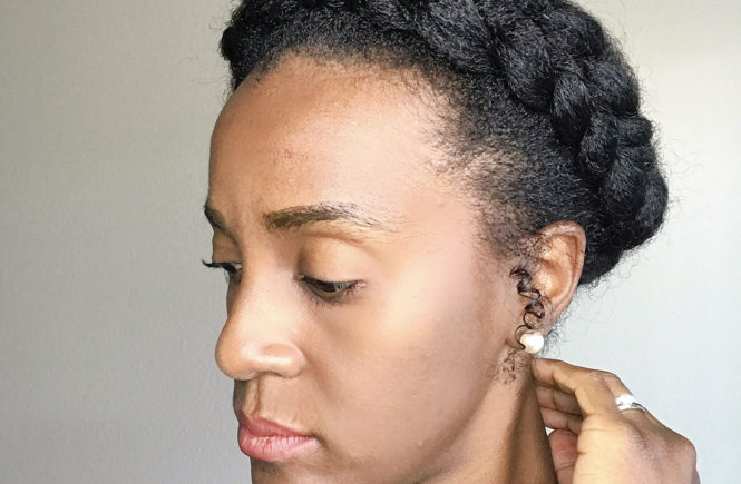 lady touching neck with protective style halo braid