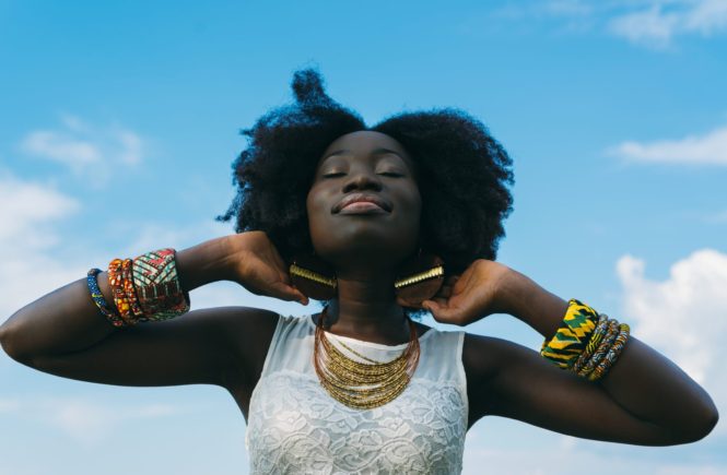 woman wearing white shirt and lots of jewelry